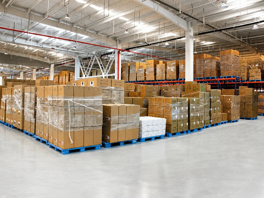 Stacked paper food packaging cartons in a warehouse for compression, humidity and transit testing